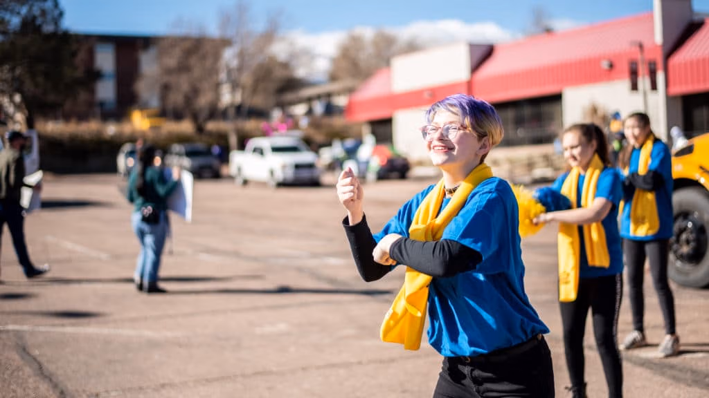CEC Students out side wearing blue shirts and yellow scarves.