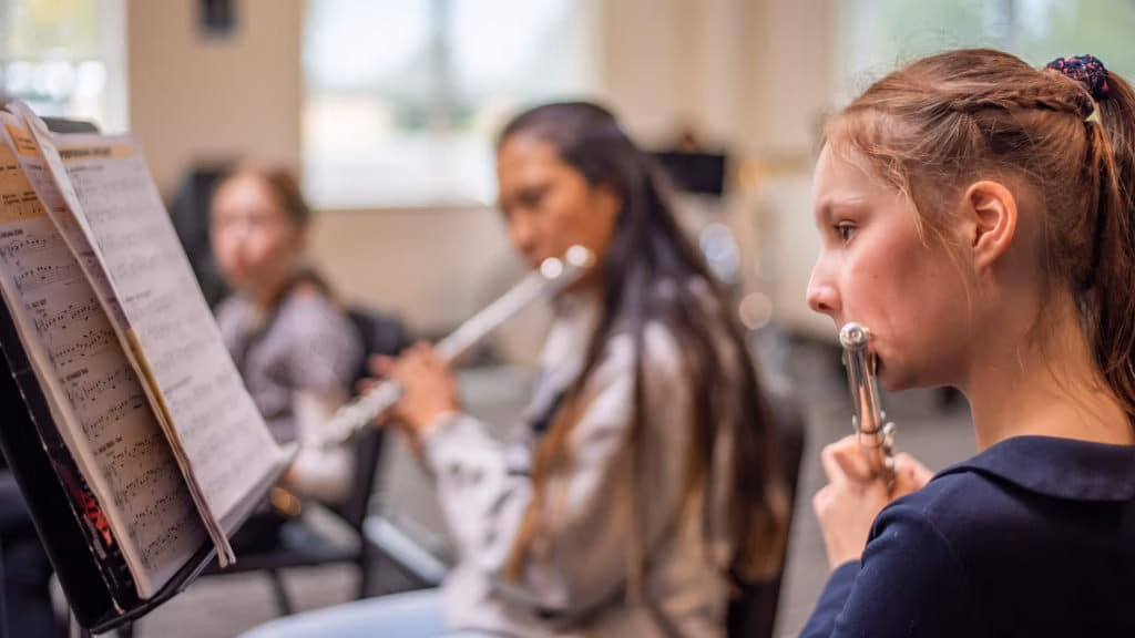 Students playing the flute in music class.
