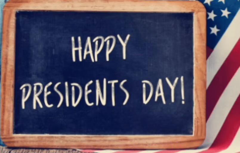 Happy Presidents Day! Chalkboard with an American flag in the background.