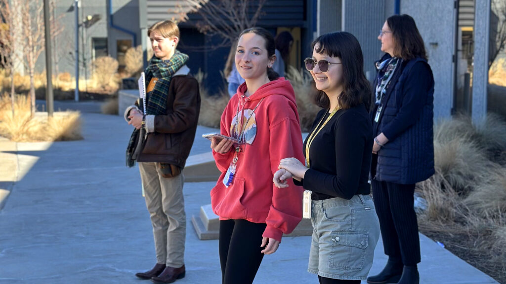 CEC Colorado Springs students and CEO Dr. Jill Gildea standing outside of the school on a chilly afternoon.