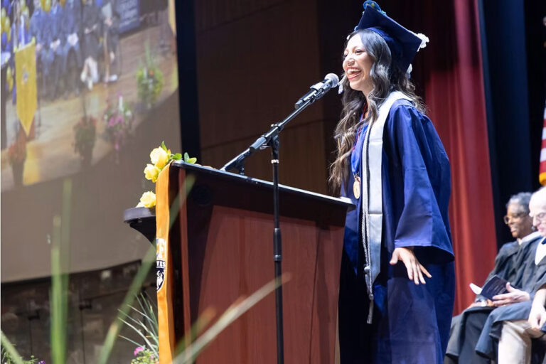 CEC Fort Collins graduate Mera Sanchez giving a graduation speech at a podium.