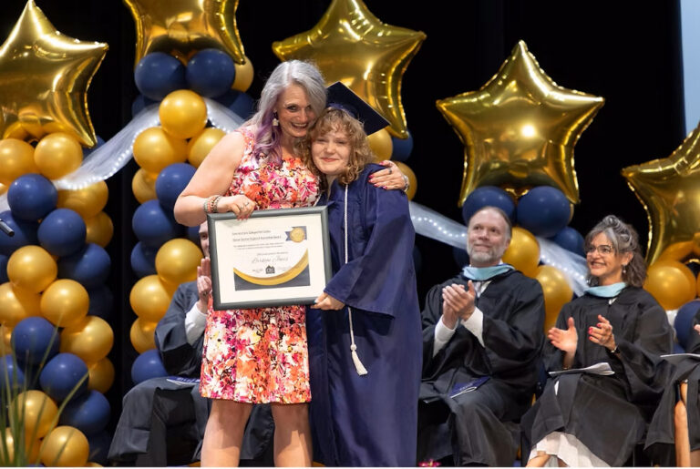 CEC Fort Collins graduate Larkyn Jones receives and award on stage during graduation.