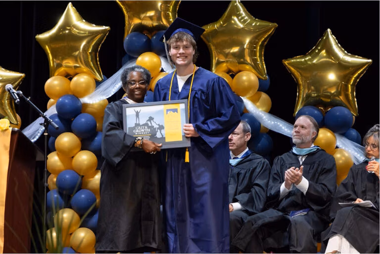 CEC Fort Collins graduate receives the Presidents award from Laura Calhoun, the President of the Governing Board.