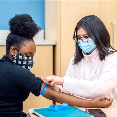 CEC Aurora student gets blood drawn for a school blood drive.