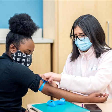 CEC Aurora student gets blood drawn for a school blood drive.