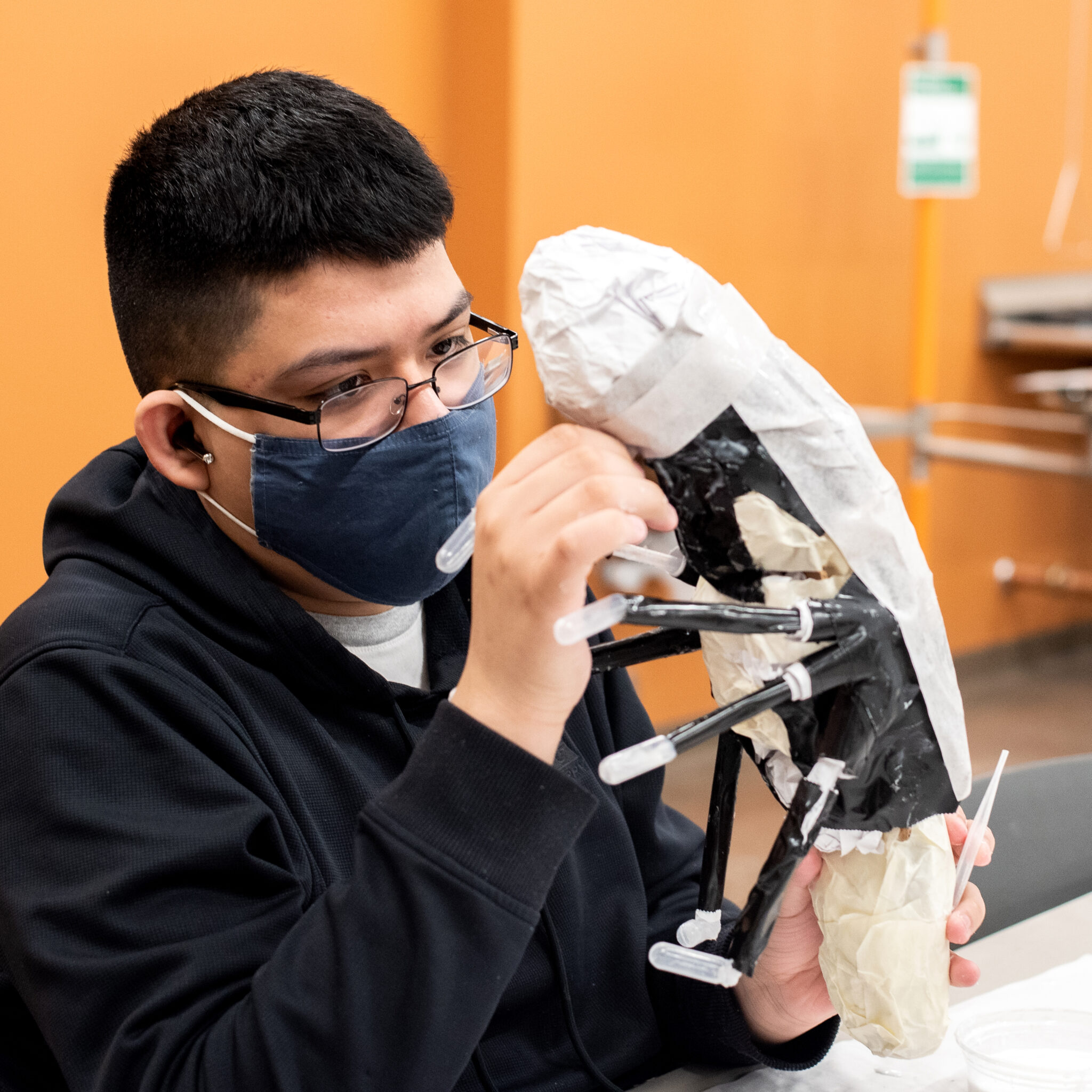 CEC Aurora student works on a sculpture at school.