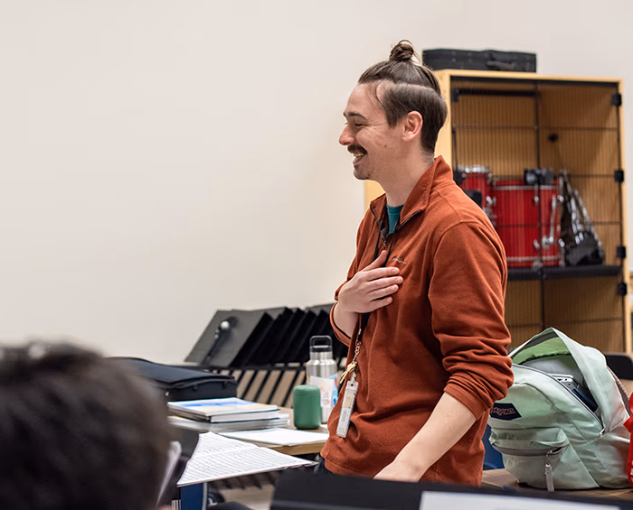 CECCR music teacher standing at the front of class.