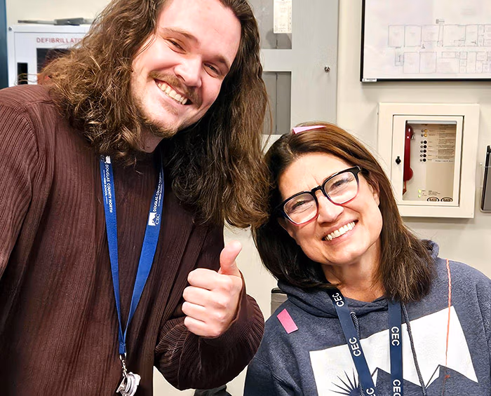 Faculty from CEC Castle Rock look at the camera and pose for a picture.