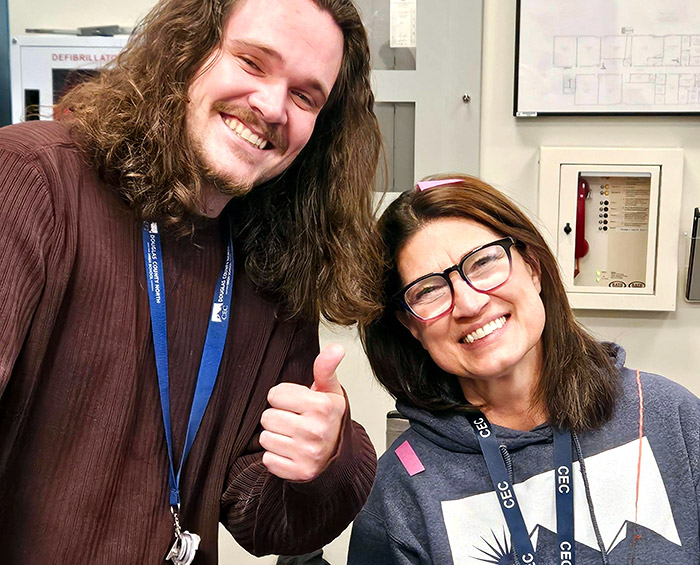 Faculty from CEC Castle Rock look at the camera and pose for a picture.