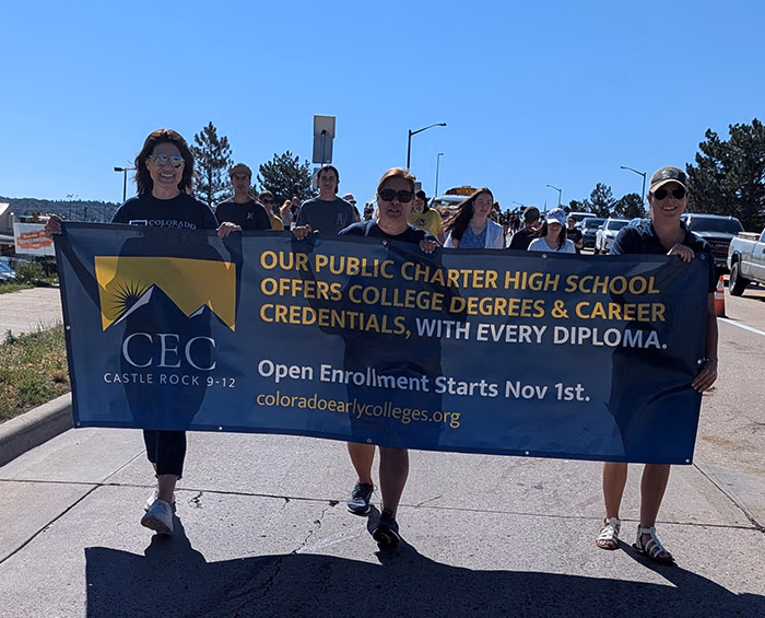 CECCR Staff holding a banner promoting CEC Castle Rock and walking in the 2025 Douglas County parade.