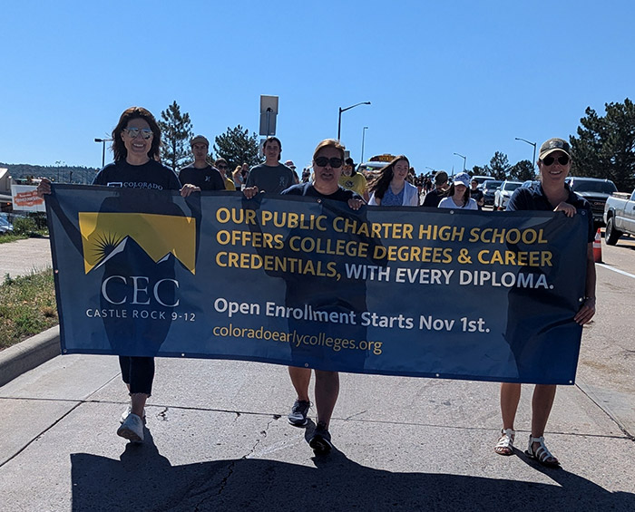 CECCR Staff holding a banner promoting CEC Castle Rock and walking in the 2025 Douglas County parade.