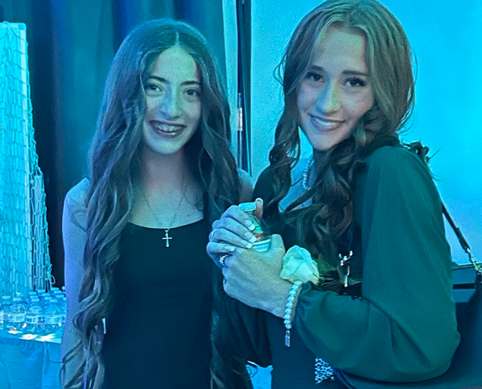 Two CEC Castle Rock students take a break during the high school dance and pose for a picture.