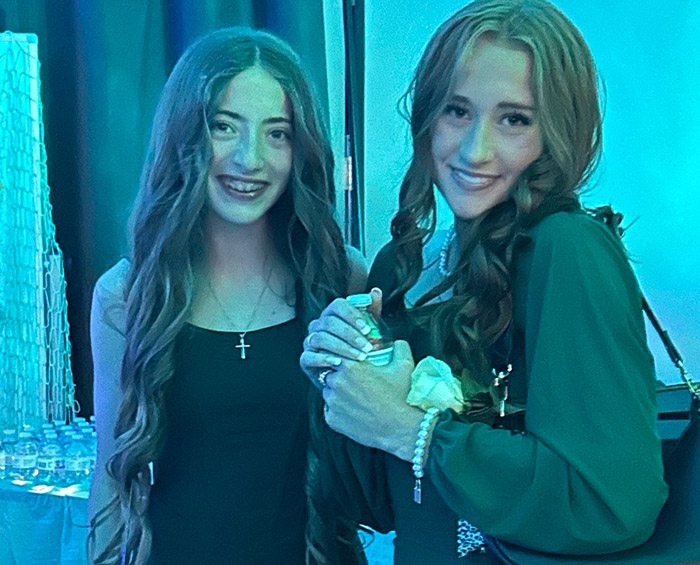 Two CEC Castle Rock students take a break during the high school dance and pose for a picture.