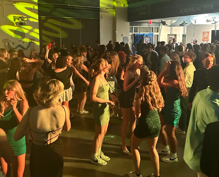 CEC Castle Rock students dance in a dark gym during a high school dance.