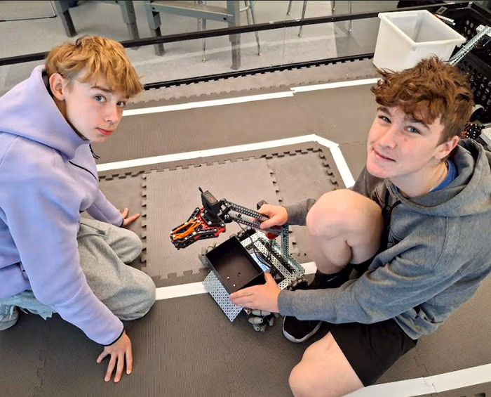 CEC Douglas County North robotics students pose for a picture while working on a robot they created.