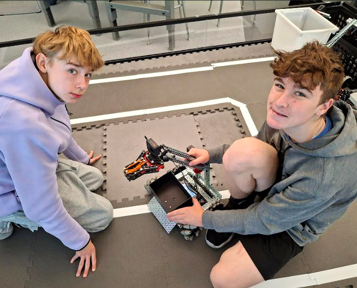 CEC Douglas County North robotics students pose for a picture while working on a robot they created.