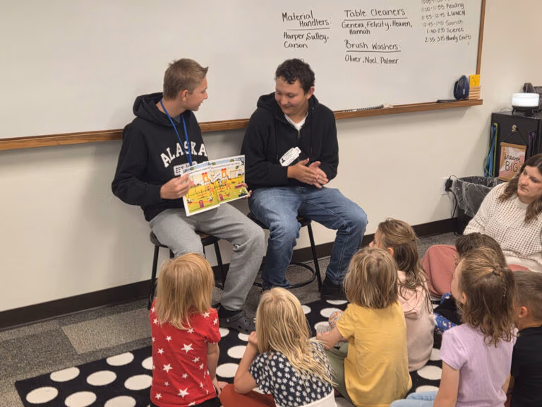 CEC Colorado Springs middle school students share a book they created in Canva with homeschool enrichment students.