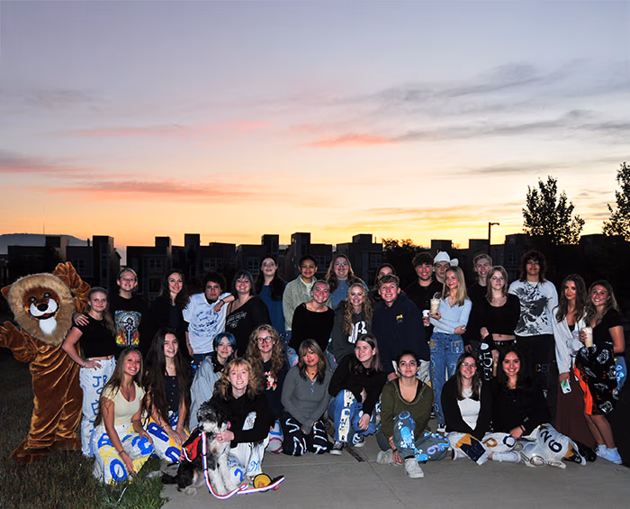 All the CECCR seniors in a group photo with the sun rising in the background.