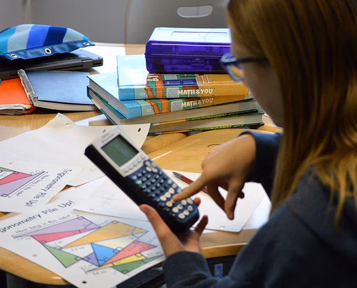 CECFC Middle School student works on schoolwork in a classroom.