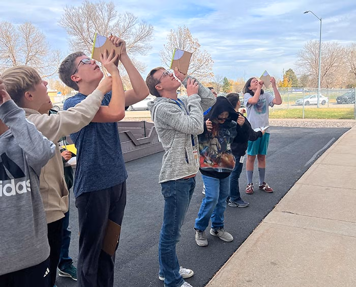 CECFC Middle School students work on a project outside the school.