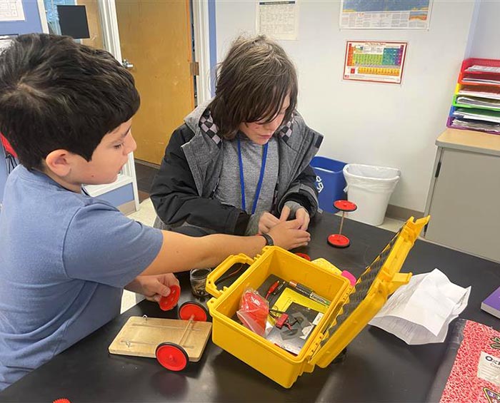 CECFC Middle School student work on a project in a classroom.