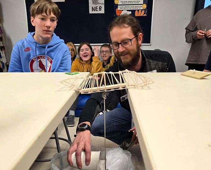 CECFC Middle School teacher and students experiment with balsa wood bridge construction.