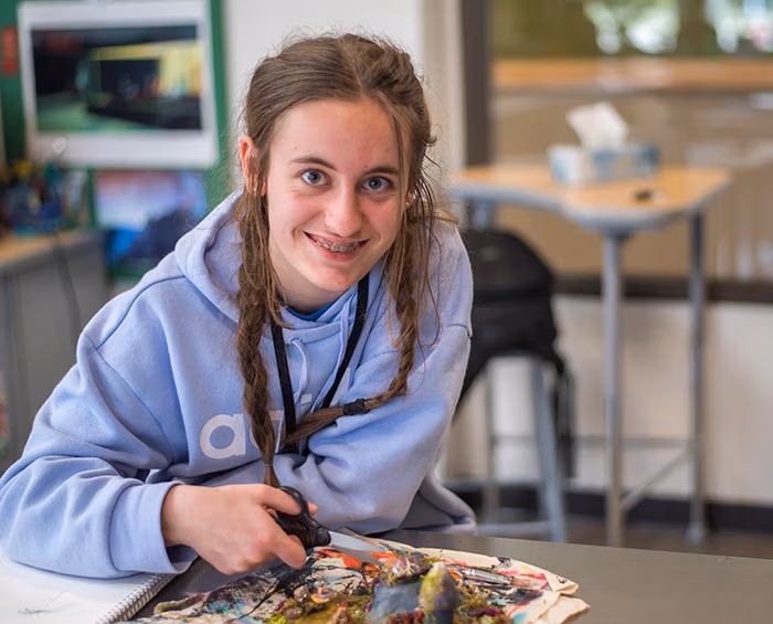CEC Windsor student working on a collage artwork project in class.