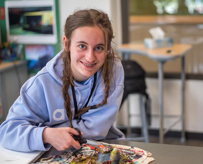 CEC Windsor student working on a collage artwork project in class.