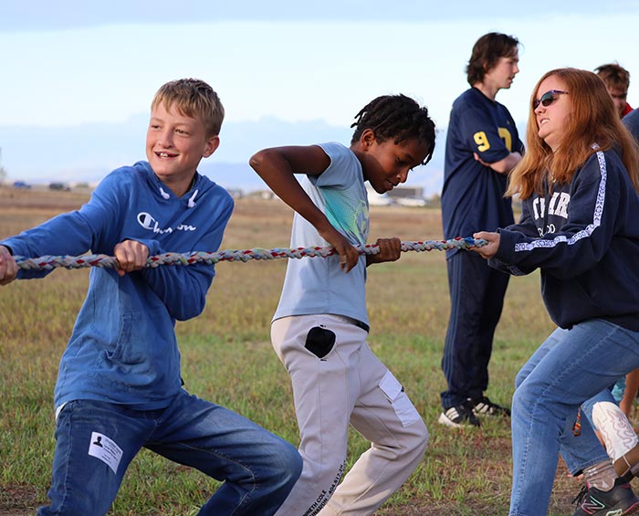 CECW Students play a game of tug of war.