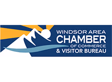 Windsor Area Chamber of Commerce & Visitor Bureau logo. Blue background with white mountains and sun rays.