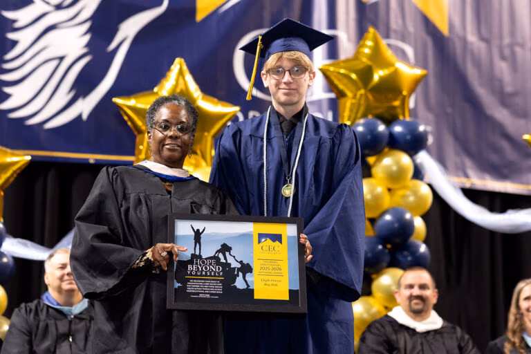 CEC Fort Collins Graduate receives the Hope Beyond Yourself award onstage at graduation.