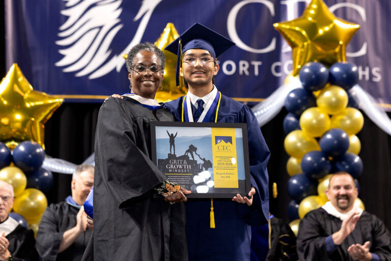 CEC Fort Collins Graduate receives the Grit & Growth award onstage at graduation.