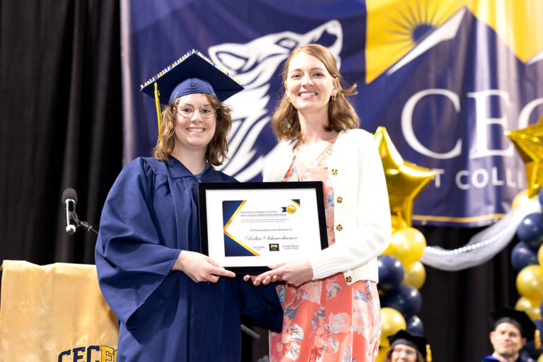 CEC Fort Collins Graduate receives and award onstage at graduation.