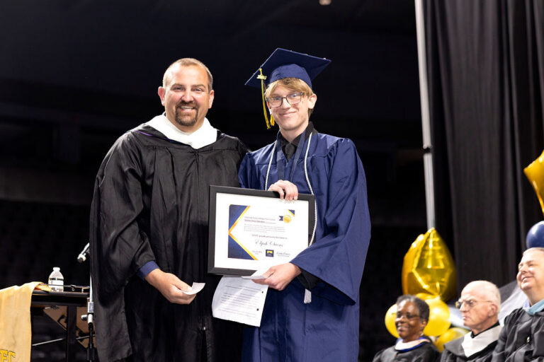 CEC Fort Collins Graduate receives an award onstage.