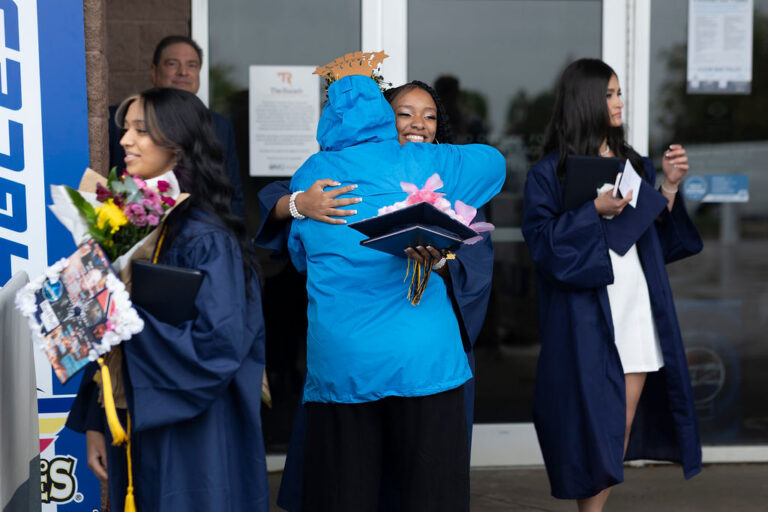 CEC Fort Collins Graduates embrace their family after graduation.