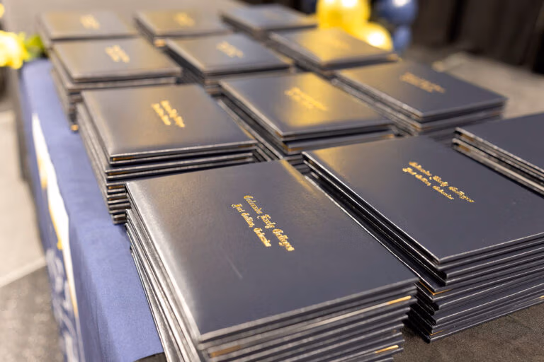 Graduation diplomas sitting on a table.